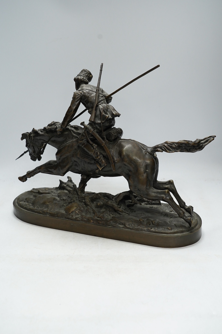 After Eugene Lanceray (Russian, 1848-1886), bronze study of a Cossack charging, signed in cyrillic, 39cm wide. Condition - good